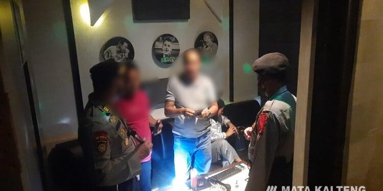 FOTO: AGUS/MATA KALTENG - Petugas saat memeriksa karti identitas kepada pengunjung Family Karaoke Sampit, Sabtu 24 Desember 2022 malam.