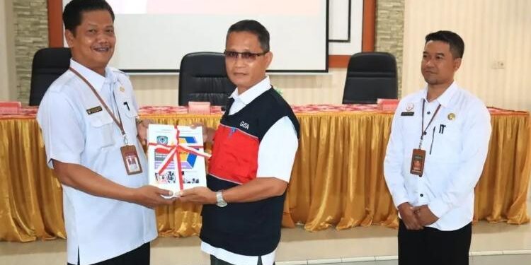 FOTO: PROKOM SERUYAN/MATA KALTENG - Sekda Seruyan, Djainu'ddin Noor (kiri) saat menerima secara simbolis pelaksanaan WBK dan WBBM dari Kepala Disdukcapil Seruyan, Domases Al Atak (tengah) di Aula BKAD Seruyan, Rabu 15 Maret 2023.