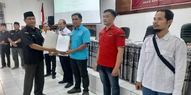 FOTO : SID/MATA KALTENG - Ketua KPU Kabupaten Gumas Stepenson menyerahkan berita acara hasil rapat pleno terbuka rekapitulasi DPS pemilu tahun 2024 ke pengurus parpol, Rabu, 5 April 2023.