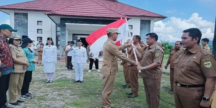 FOTO: DISKOMINFO SANTIK/MATA KALTENG - Bupati Gumas Jaya S Monong didampingi Wakil Bupati Efrensia LP Umbing, Kapolres AKBP Asep Bangbang Saputra, dan Kepala Kesbangpol Sugiarto, ketika menyerahkan bendera merah putih pada pencanangan gerakan pembagian bendera merah putih tahun 2023, Selasa 27 Juni 2023.