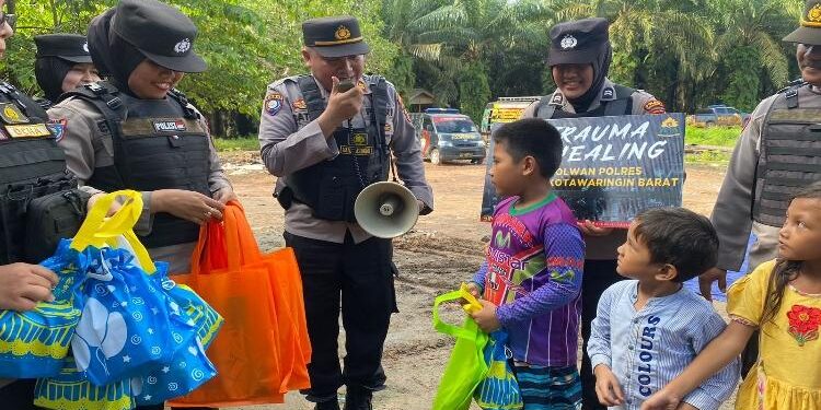 FOTO: HUMAS POLDA/MATAKALTENG - Personel Polres Kotawaringin Barat, pada saat memberikan trauma healing kepada anak-anak dan ibu di PT BJAP.