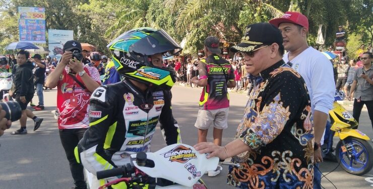 FOTO : AGUS/MATA KALTENG - Bupati Kotim Halikinnor ditemani Wakil Bupati Irawati dan Ketua IMI Kotim Angga Aditya Nugraha memberikan semangat kepada para pembalap yang ikut berpartisipasi dalam ajang balapan motor yang berlangsung di Sirkuit Taman Kota Sampit, Kotim. Sabtu, 29 Juli 2023.