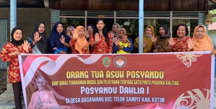 FOTO : IST/MATAKALTENG - Ketua DWP DPMPTSP Provinsi Kalimantan Tengah Cintya Asmara Dewi Sutoyo (tengah) berfoto bersama dengan warga di Desa Basawang, Kecamatan Teluk Sampit, Kabupaten Kotim, Senin 18 September 2023.