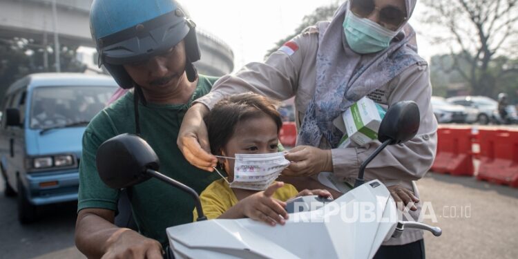 FOTO: IST/MATAKALTENG - Petugas dari Dinas Kesehatan Barsel, saat membagikan masker kepada pengguna jalan di Kota Buntok.