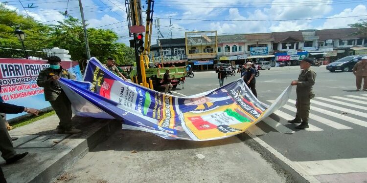 FOTO: RZL/MATAKALTENG - Petugas gabungan saat menertibkan APS caleg yang melanggar aturan.