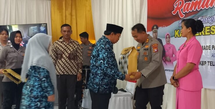 FOTO : AKH/MAKA - Pj Bupati Sukamara Kaspinor saat memberikan cindera mata kepada AKBP Dewa Made Palguna saat acara kenal pamit Kapolres Sukamara.