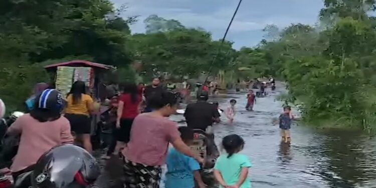 FOTO:IST/MATAKALTENG - Masyarakat Kota Buntok ramai bersama keluarga mandi di kawasan Jalan Barito Raya yang tenggelam karena banjir.