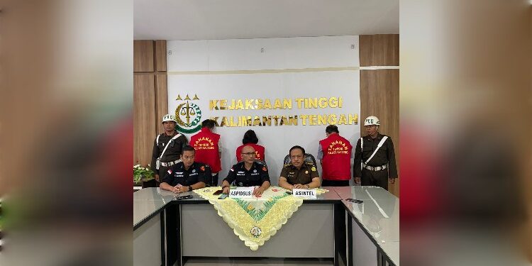FOTO: IST/MATAKALTENG - Tiga tersangka dana BOK Dinkes Barsel di giring ke mobil tahanan usai menjalani konfrensi pers di salah satu ruangan Kejati Kalteng.