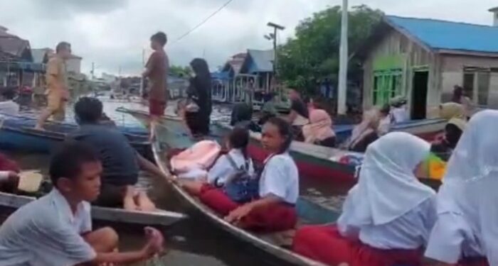 Foto: BPBD/MATA KALTENG - Anak-anak Desa Hanjalipan saat berangkat sekolah ketika banjir.