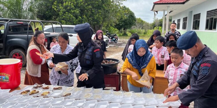 FOTO: MATAKALTENG - Personel Brimob Polda Kalteng pada saat menyiapkan nasi kota untuk para siswa di SDN 4 Tangkiling.