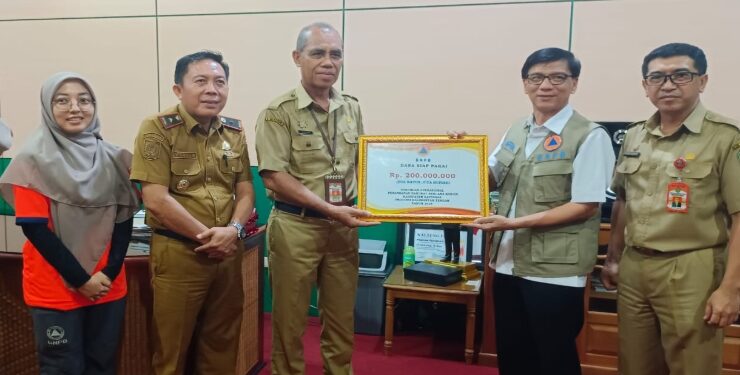 FOTO : IST/MATAKALTENG - Sekda Katingan Pransang, saat menerima bantuan secara simbolis berupa plakat Dana Siap Pakai dari pihak BNPB Provinsi Kalteng.