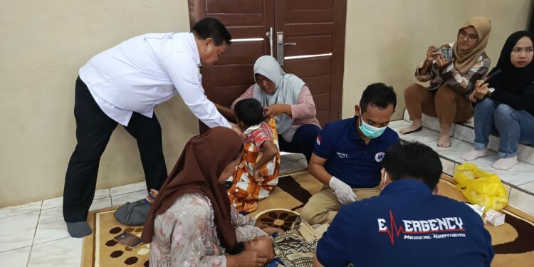 FOTO ; DEVIANA/MATAKALTENG - Bupati Kotim Halikinnor saat membatu peserta khitanan massal kesulitan melepas baju, Rabu 3 Juli 2024.