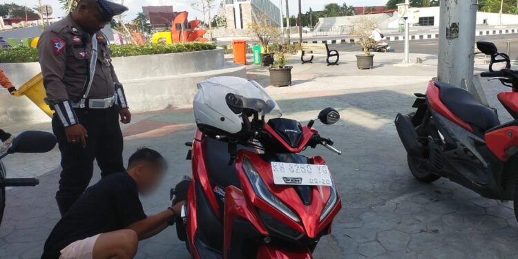 FOTO: MATAKALTENG - Salah seorang pengendara yang tengah melepas knalpot miliknya yang tak sesuai spesifikasi teknis.