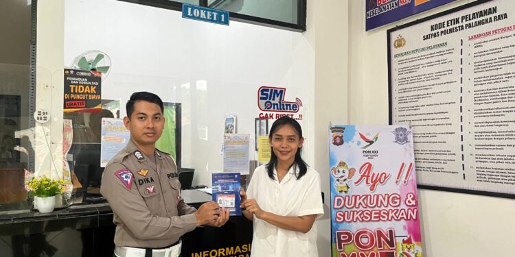 FOTO: MATAKALTENG - Personel Satlantas Polresta Palangka Raya, pada saat menyerahkan SIM kepada salah seorang masyarakat.