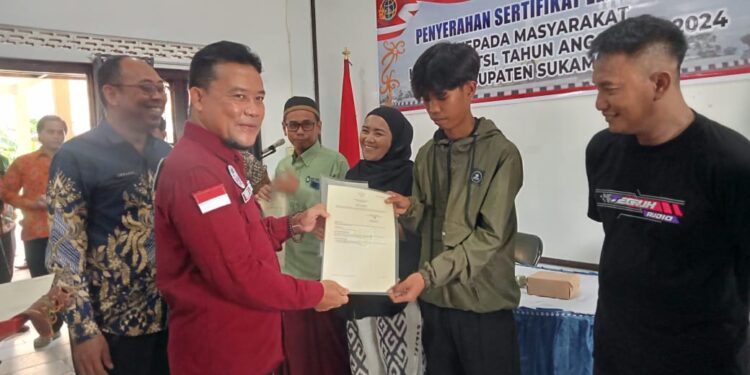 Foto : AKH/MATA KALTENG - Pj Bupati Sukamara Rendy Lesmana saat menyerahkan sertifikat tanah elektronik kepada warga.