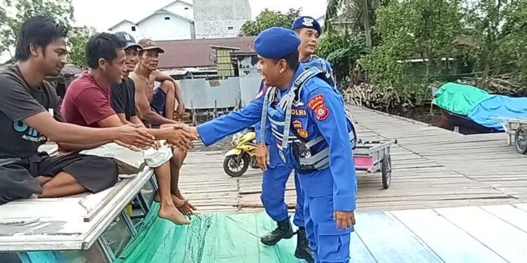 FOTO: MATAKALTENG - Personel Ditpolairud Polda Kalteng pada saat menyambangi warga.