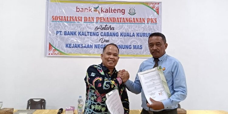 FOTO : KEJARI GUMAS/MATA KALTENG - Kejari Gumas Sugito dan Pimpinan Bank Kalteng Cabang Kuala Kurun Soleman Hukubun, menunjukkan kesepakatan bersama yang sudah ditandatangani, di aula Hotel Insevas, Kamis, 27 Februari 2025.