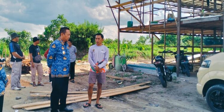 FOTO : MATAKALTENG - Bupati Sukamara, Masduki saat memantau kandang ayam yang dibangun dipinggiran kota Sukamara.