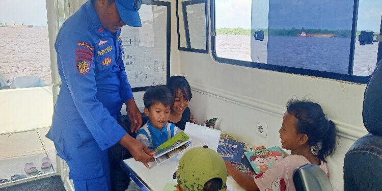 FOTO: IST/MATAKALTENG- Terlihat anak-anak pesisir sungai Mentaya semangat belajar di atas kapal Ditpolairud Polda Kalteng.